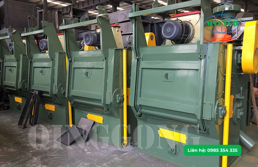 Máy phun bi thùng đảo (hay còn gọi là máy phun bi băng tải cuốn)